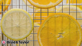 Pleasant guitar music A timelapse of citrus slices dehydrating. Text overlay states “Brod & Taylor. Sahara Folding Dehydrator.” A man demonstrates how to unfold/set up the dehydrator and lays out dehydrated foods while the text overlay states “The world’s only folding dehydrator. Powerful 750W dual heaters. Stainless steel shelves, 11 square feet of drying area. Quiet fan, high efficiency airflow, washable air filter. Precise dual-time/temperature controls.”